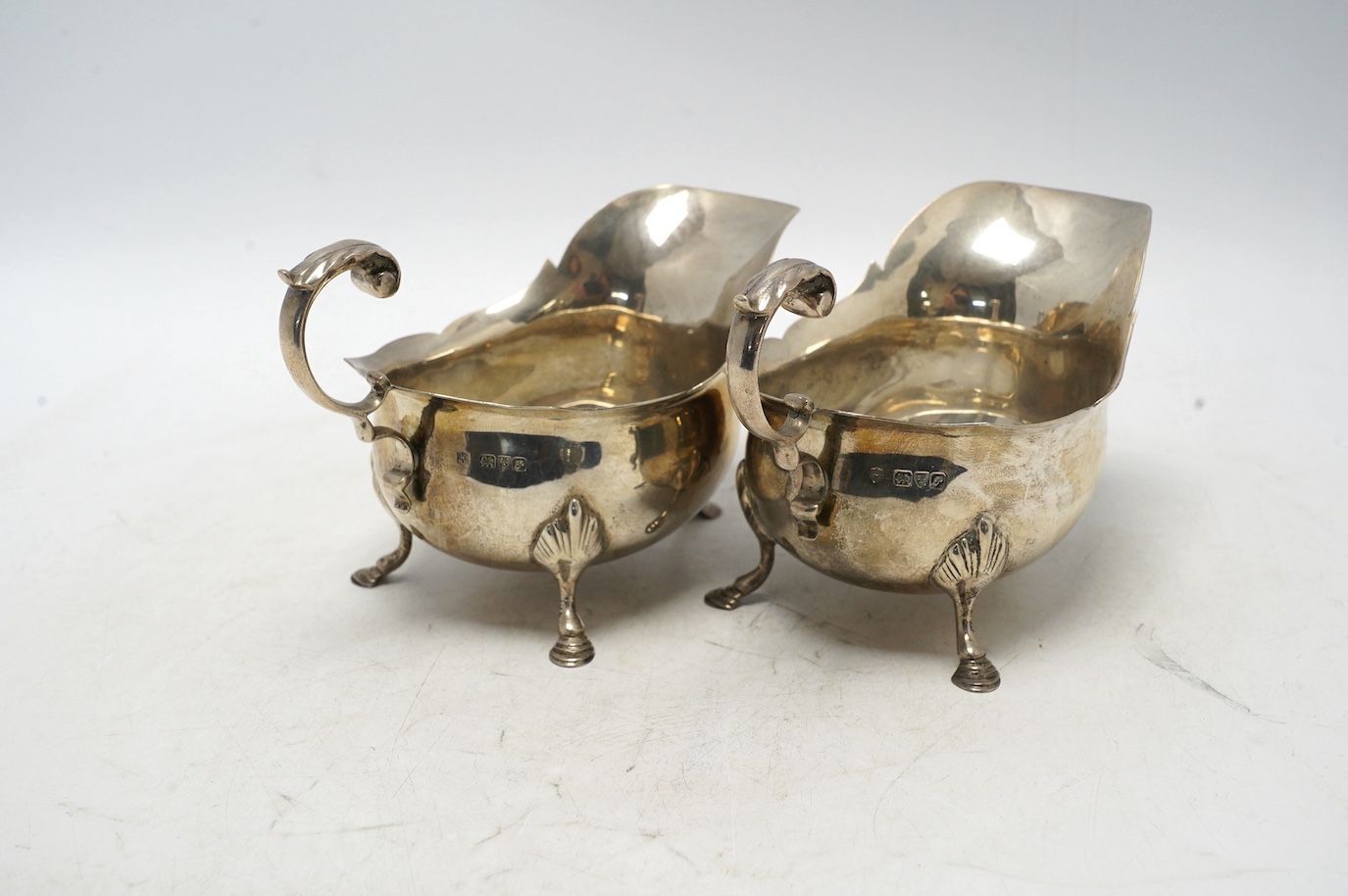 A pair of George V silver sauce boats, Nathan & Hayes, Chester, 1915, length 16.1cm, 12.6oz. Condition - fair